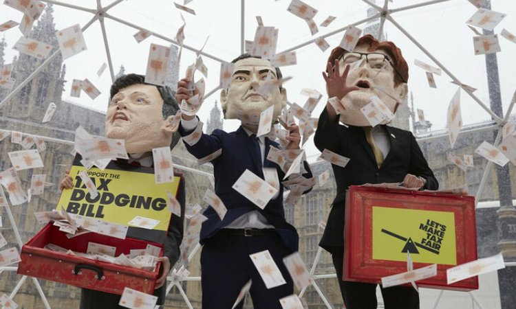 Campaigners from the Tax Dodging Bill campaign dressed up as George Osborne, Ed Balls and Danny Alexander, holding budget boxes to take part inside a cash grab inside a crystal maze style dome to represent the vast amounts of cash lost to tax dodging.