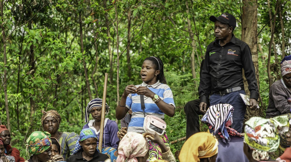 Marie Nsimire, farmer and participant of the BMZ project. She stands in Lurhala community fields talking to women of her community about the work that has happened so far.