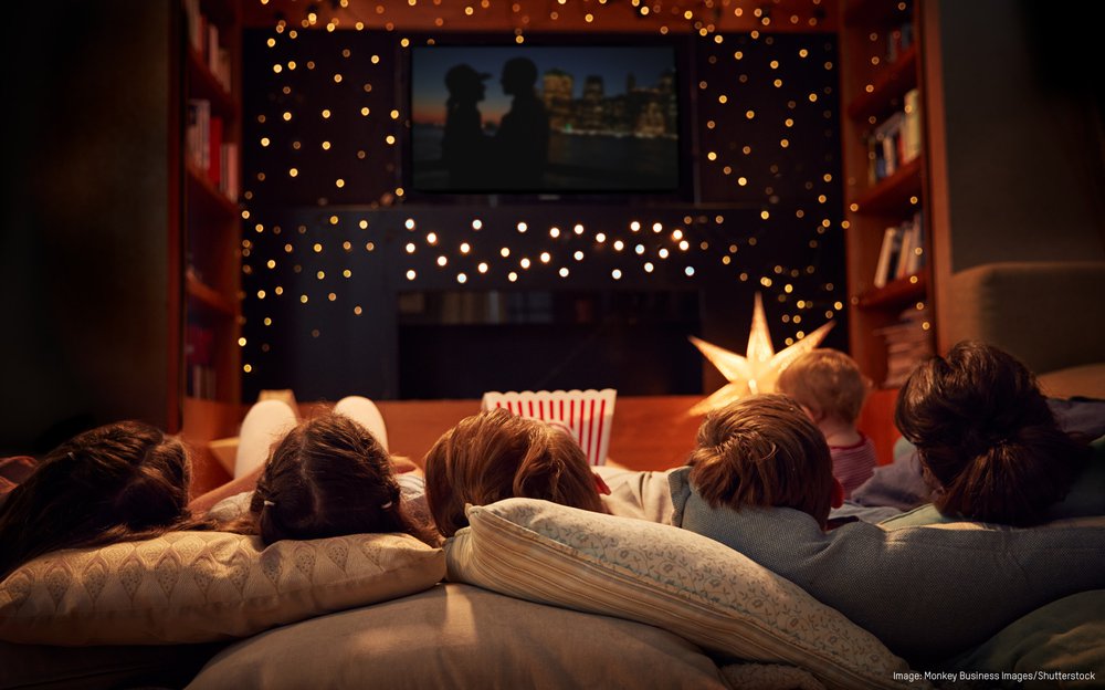 A stock photo of cozy people watching a movie at home