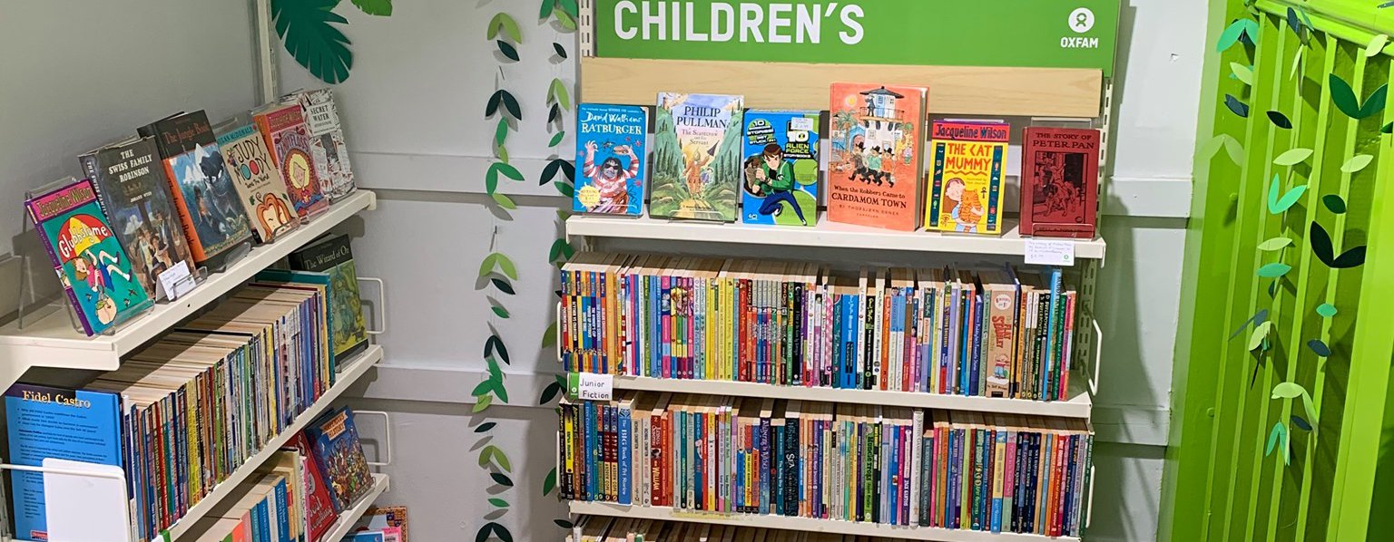 Oxfam Preston's children's books section with new monkey mural on the wall and a toget foot cushion on the floor