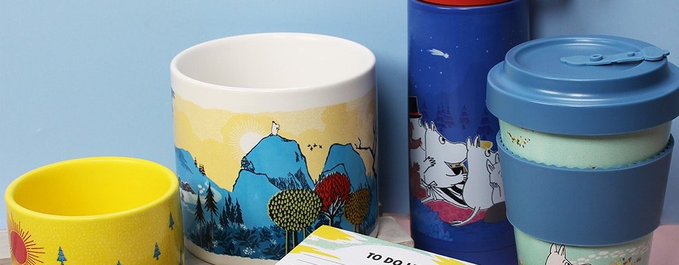 Collection of Moomin products exclusive to Oxfam including a plant pot, flask, travel mug, note pad and pencils