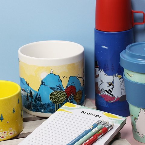 Collection of Moomin products exclusive to Oxfam including a plant pot, flask, travel mug, note pad and pencils