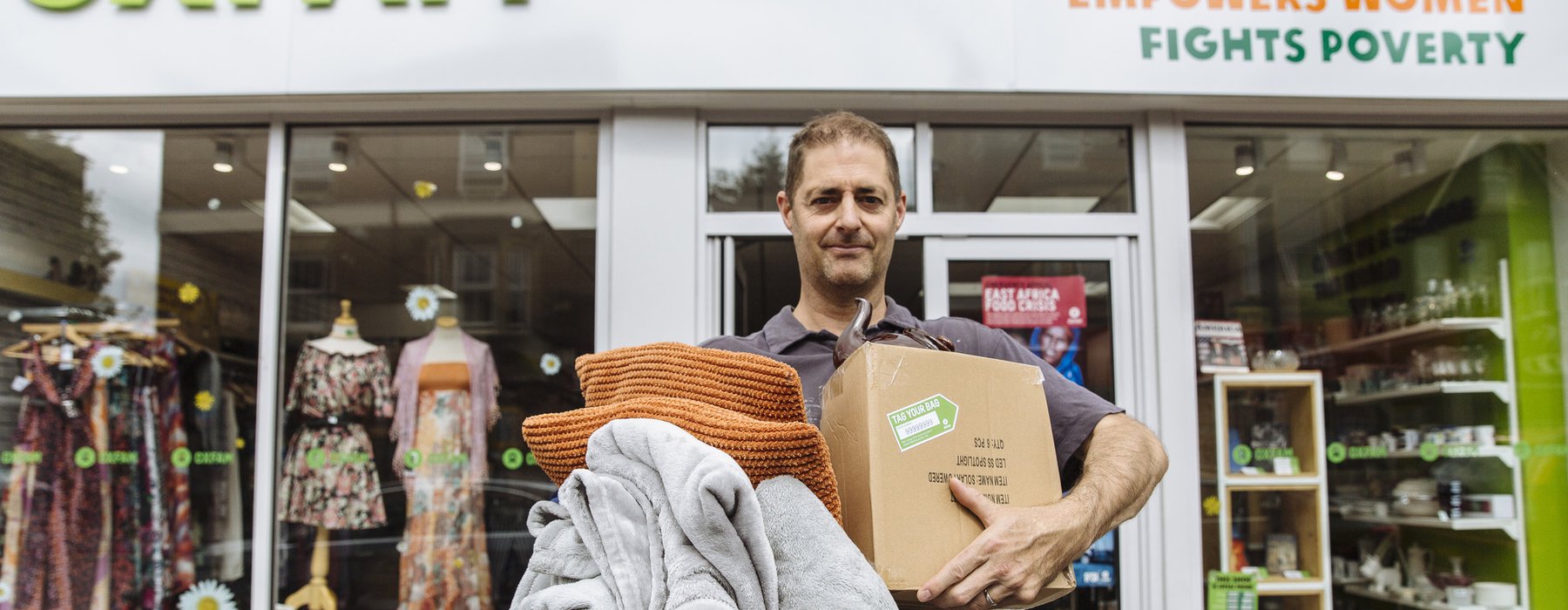 David Franklin poses with items to donate outside the Oxfam shop on Cowley Road, Oxford