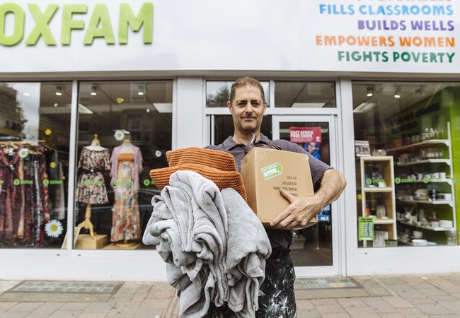 David Franklin poses with items to donate outside the Oxfam shop on Cowley Road, Oxford