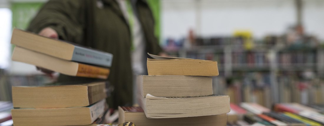 A pile of books in the Oxfam Bookshop at Hay Festival.