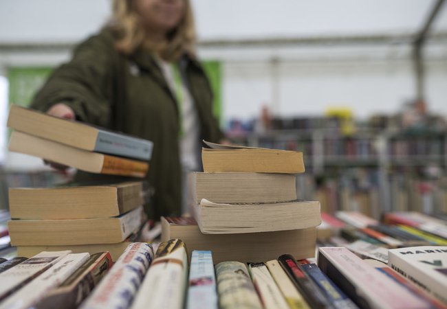 A pile of books in the Oxfam Bookshop at Hay Festival.