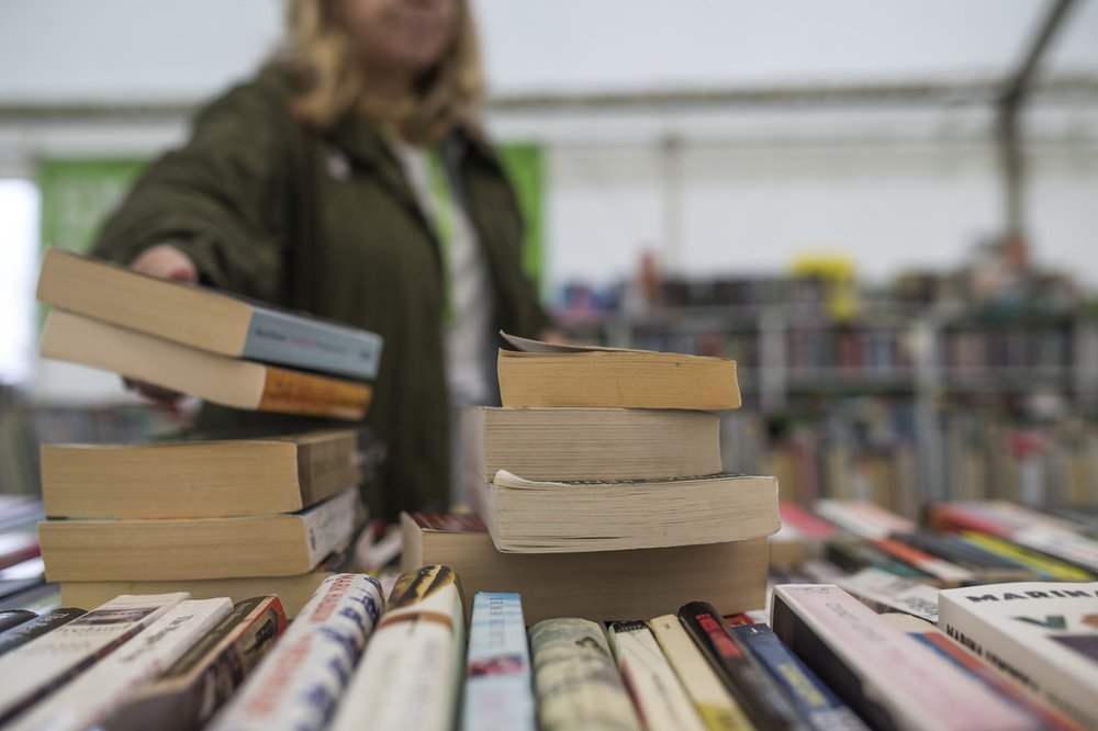 A pile of books in the Oxfam Bookshop at Hay Festival.