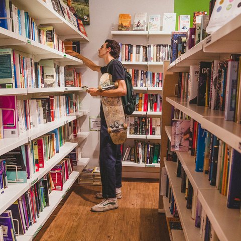 Lewis, 19, browses books in the Oxfam Books and Music Shop in Chorlton.