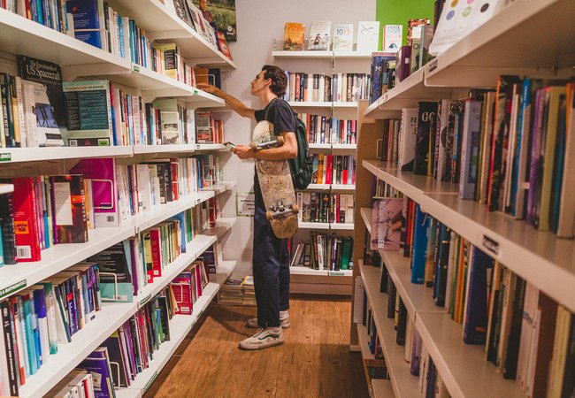 Lewis, 19, browses books in the Oxfam Books and Music Shop in Chorlton.