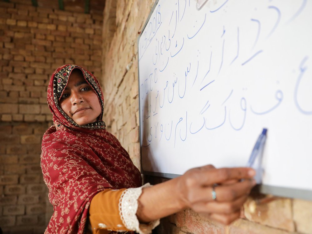 Teacher writing on a whiteboard in Pakistan