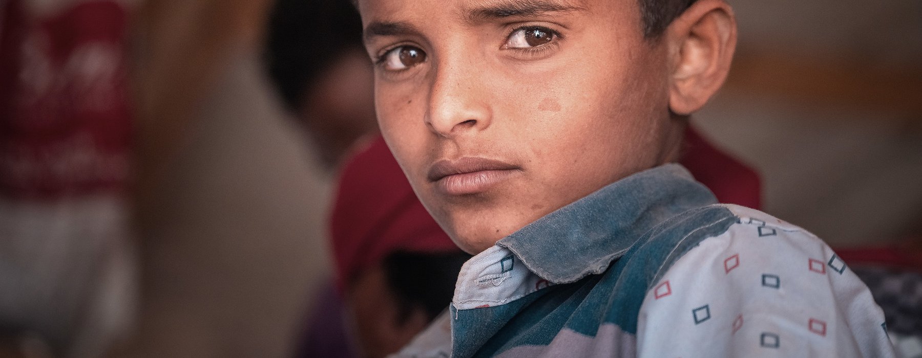 A close up of a young boy's face in Yemen