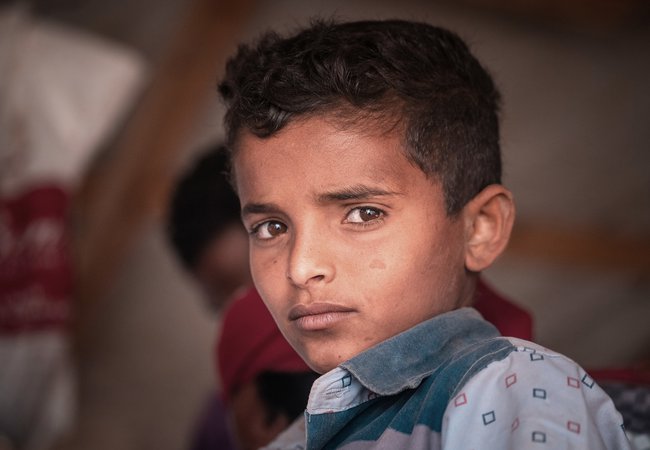 A close up of a young boy's face in Yemen