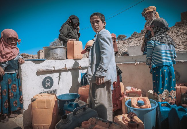 Children filling their jerrycans with water, Yemen.