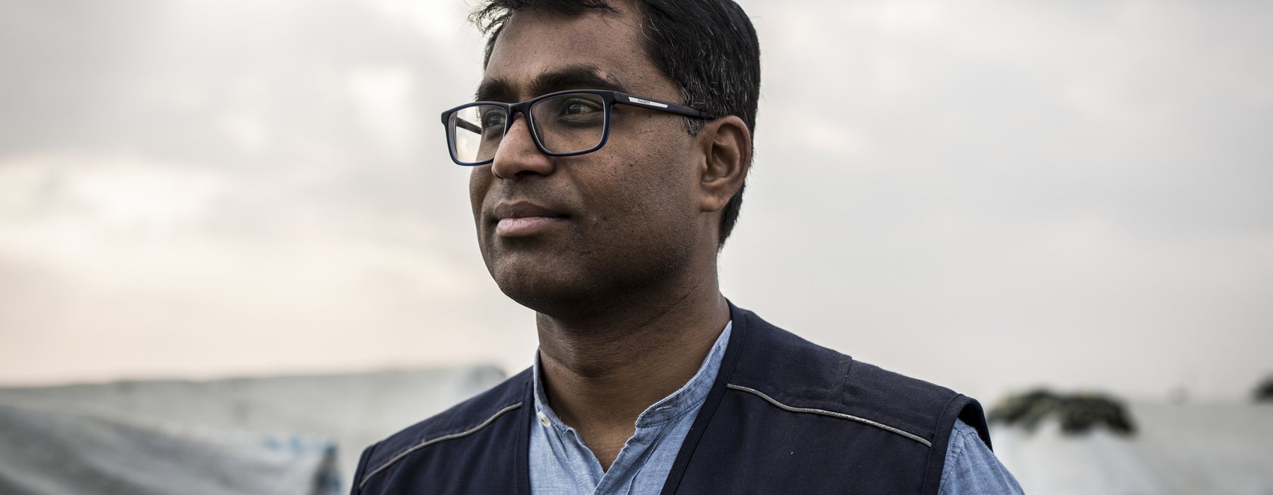 A portrait of Dhananjayan Sriskandarajah wearing a black Oxfam vest.