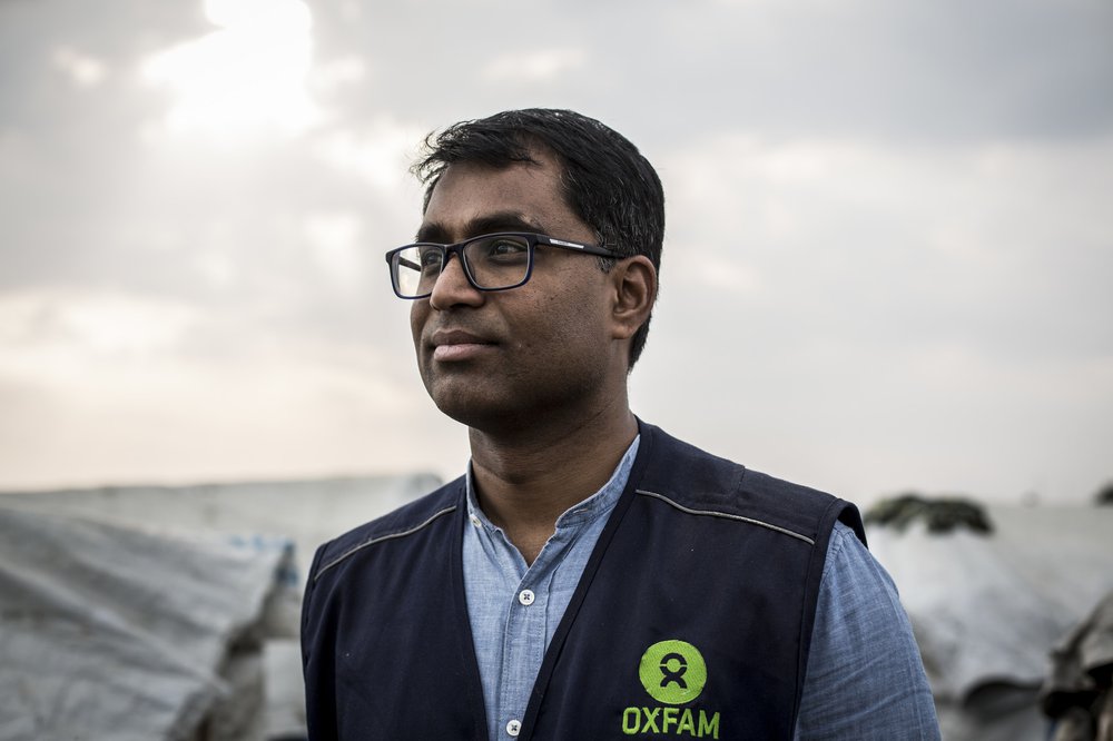 A portrait of Dhananjayan Sriskandarajah wearing a black Oxfam vest.