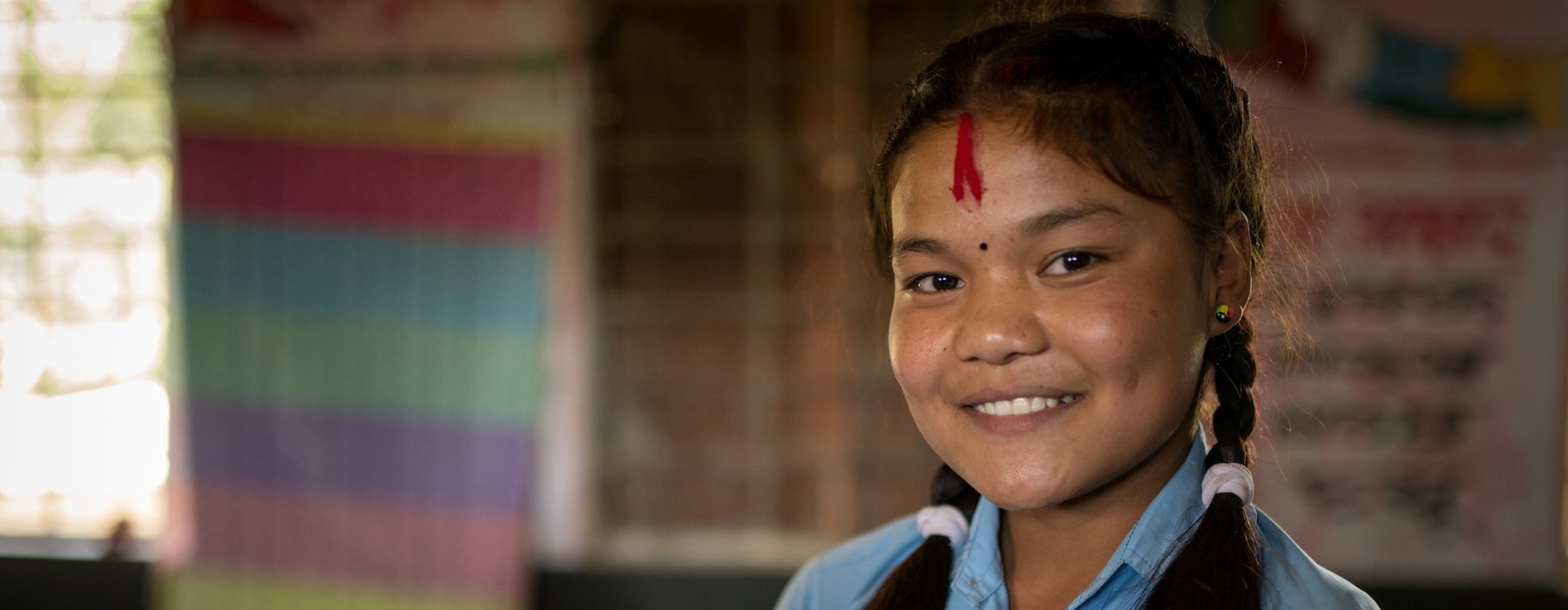 Reema* (15yrs) stands in a classroom in a village in Nepalgunj district, Nepal.