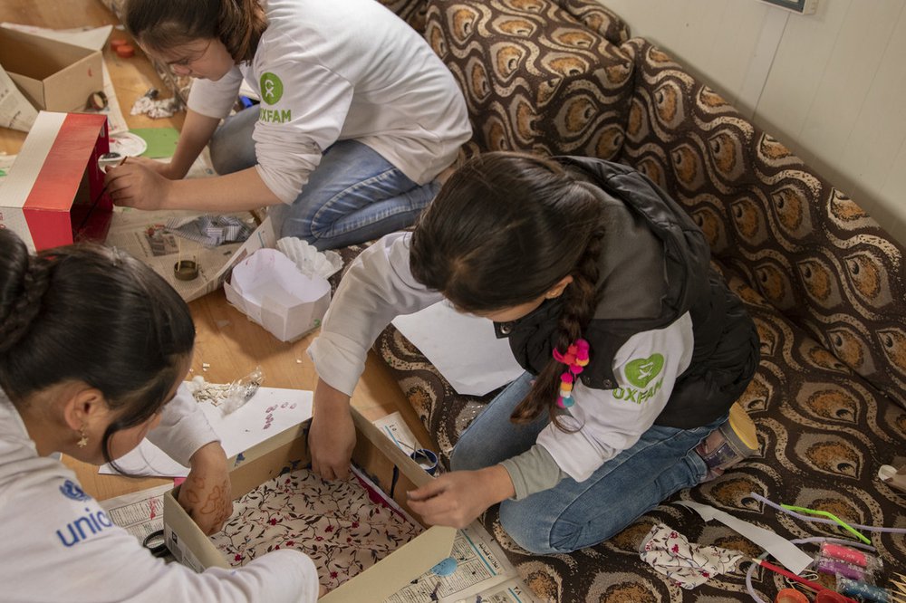 Two girls are making a fashion shop inside a shoebox in Oxfam’s community centre in Jordan’s Za’atari camp. It has dresses, a hanger for the dresses, and a painted water bottle which they made it into a mannequin wearing an Indian sari.