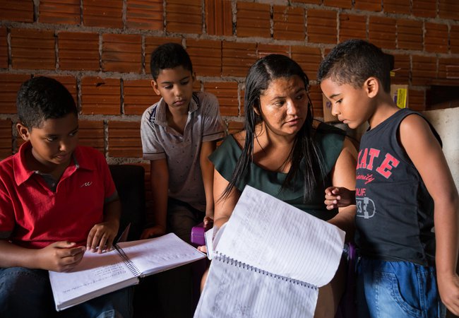 Cicera, 28, helps her children with homeschool reading.