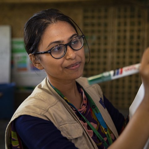 Iffat, Senior Innovation Office talks to the Oxfam team about community consultation tools for WASH infrastructure.