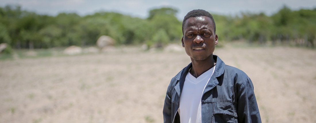 Mpumelelo Somfula standing in his recently cultivated maize field