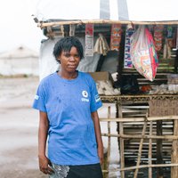 Sonia outside her shop in Mozambique
