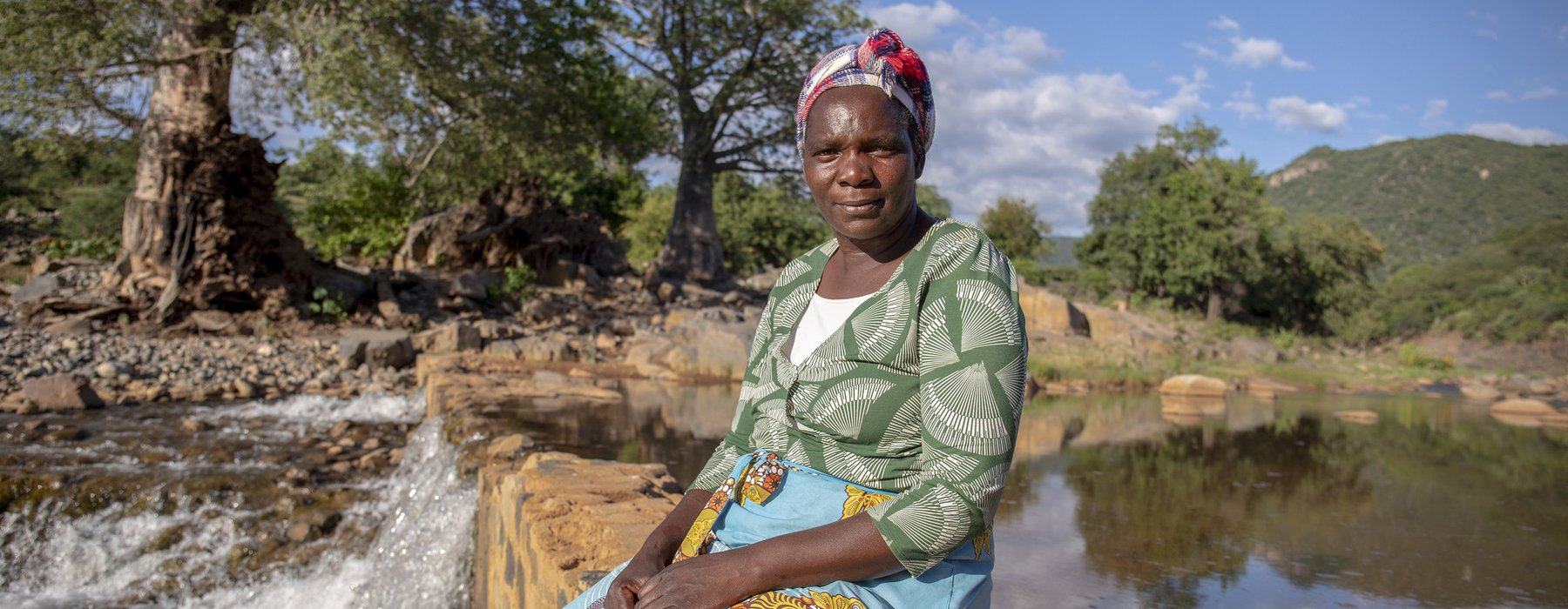 Sarah sits by the water at Nyanyadzi river, Chimanimani, Zimbabwe