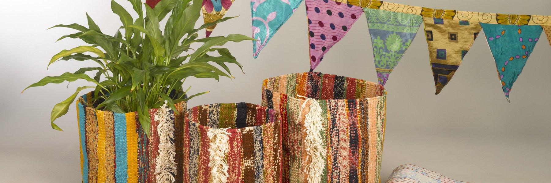 A selection of colourful baskets and bunting made from recycled saris