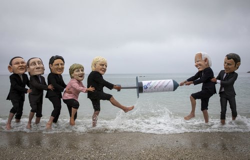 Campaigners from Oxfam and The People’s Vaccine Alliance pose as world leaders at the G7 summit in Cornwall, 2021.