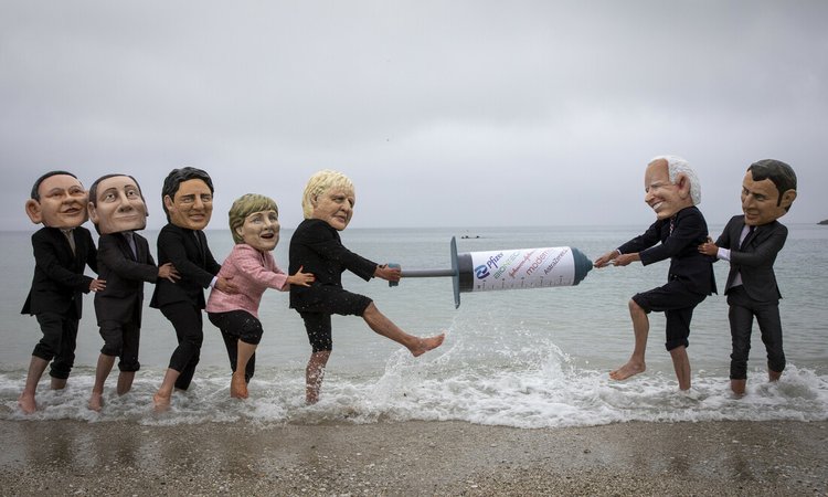 Campaigners from Oxfam and The People’s Vaccine Alliance pose as world leaders at the G7 summit in Cornwall, 2021.