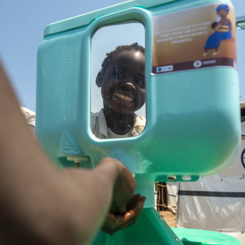 Kapinga washes his hands.
