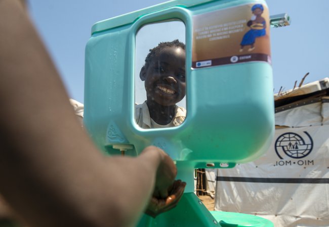 Kapinga washes his hands.