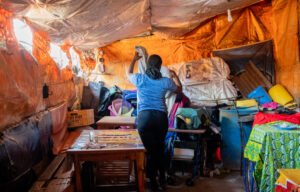 Mirabel Otieno* folds clothes in Mathare, Nairobi, Kenya.