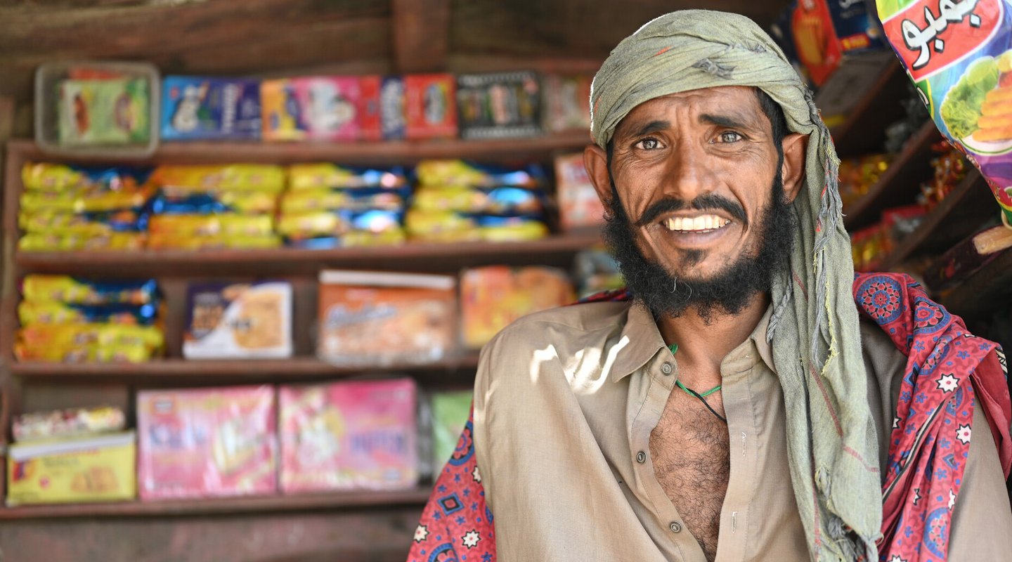 Ghulam smiles as he stands in his roadside shop in District Sanghar, Sindh, Pakistan.