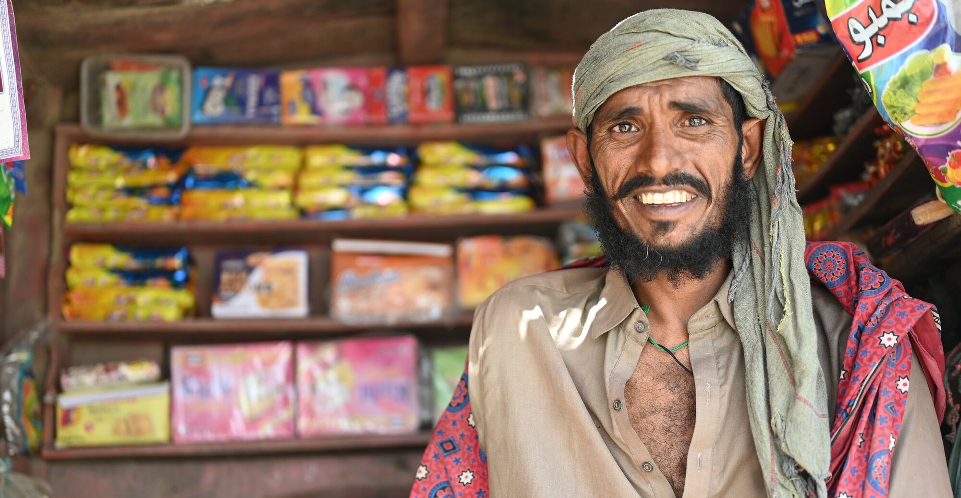 Ghulam smiles as he stands in his roadside shop in District Sanghar, Sindh, Pakistan.
