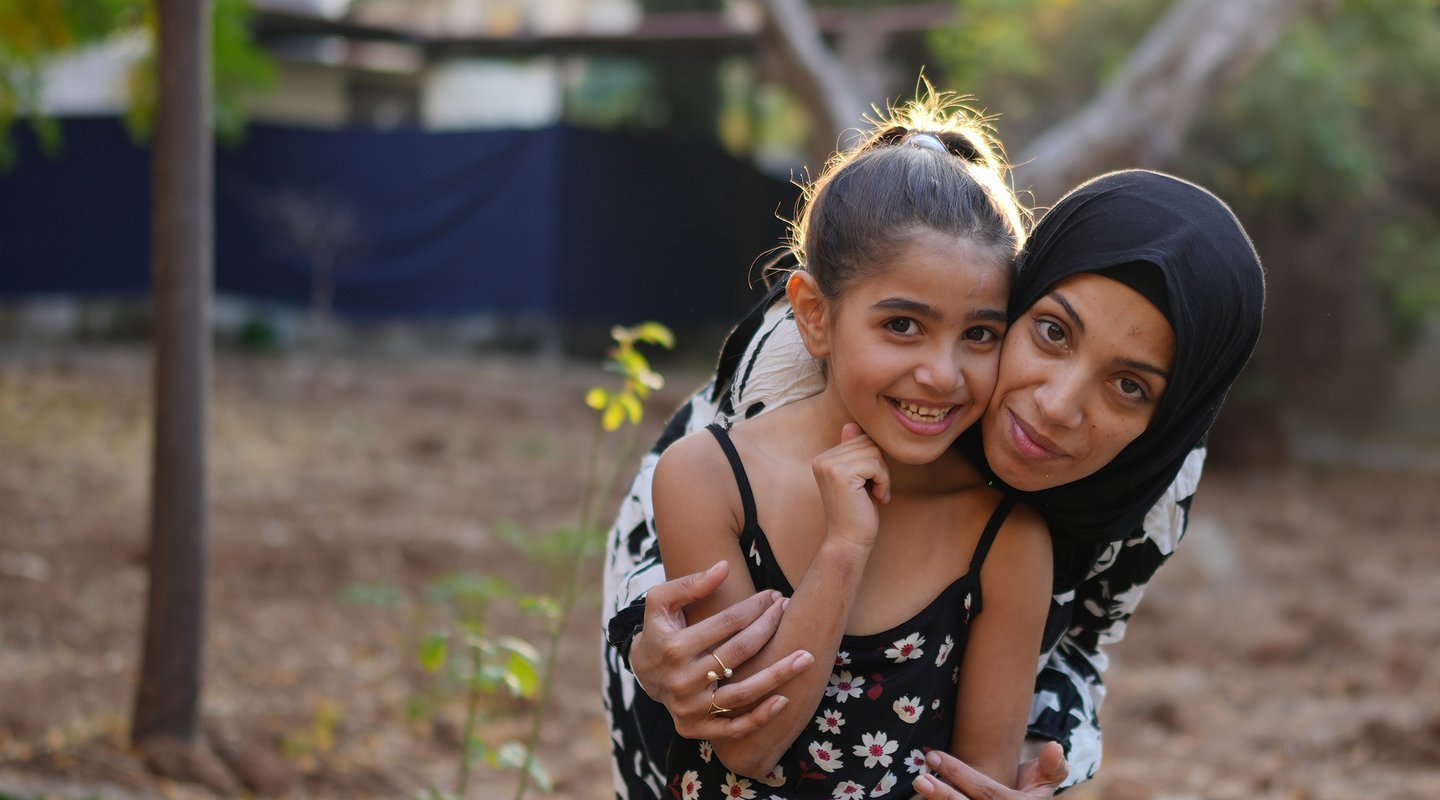 Siham, a displaced woman from Lebanon, with her 7-year-old daughter, after undergoing eye surgery