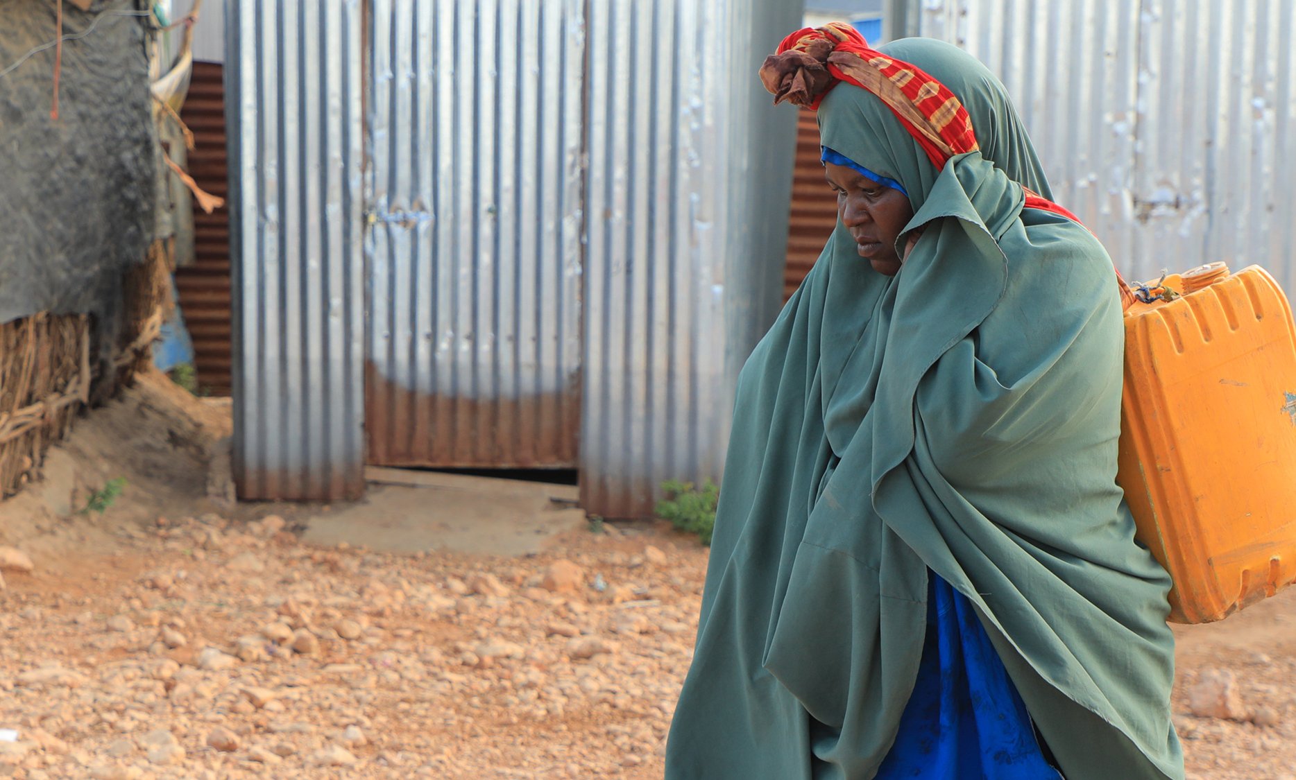 Saada Abdulahi carrying jerrycan of water.