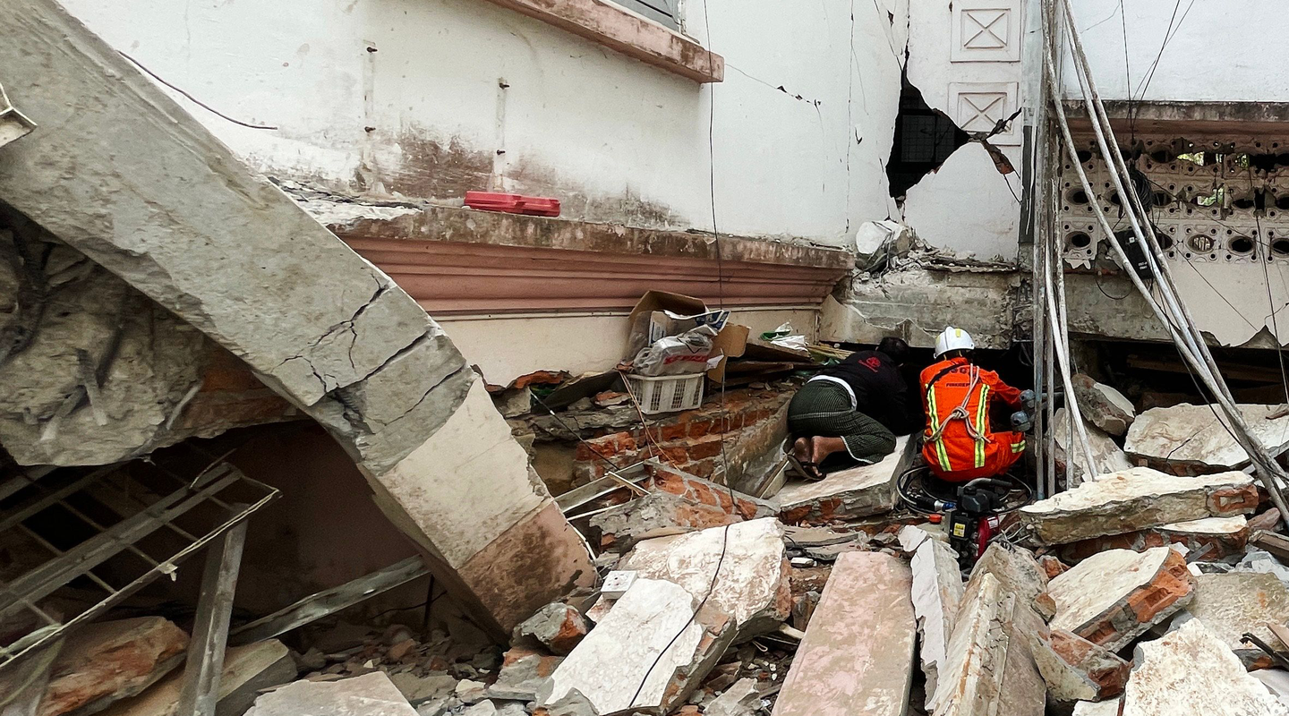 Rescuers search for survivors in damaged government staff housing buildings following an earthquake in Naypyidaw, Myanmar.