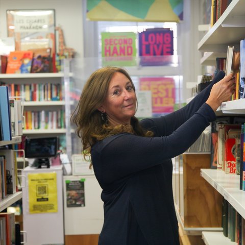 Volunteer Catherine sorting books at the Herne Hill Oxfam Bookshop.