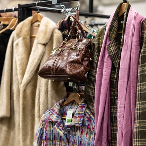 A fashionable clothing rail with coats and bags.