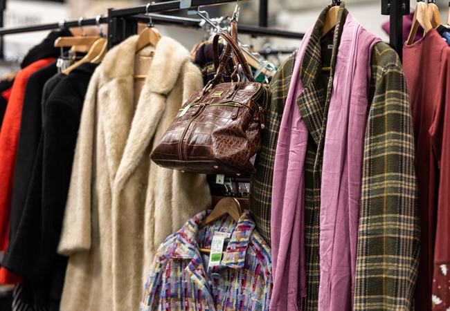 A fashionable clothing rail with coats and bags.