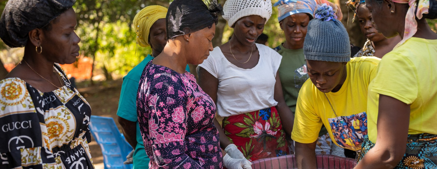 Magdalene Bangura (centre), the leader of Female Pastors Network (FEMINET) leads the gari making process at her home in Port Loko, Sierra Leone.