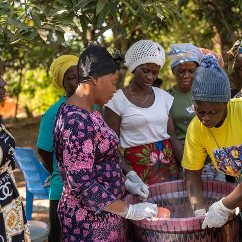 Magdalene Bangura (centre), the leader of Female Pastors Network (FEMINET) leads the gari making process at her home in Port Loko, Sierra Leone.