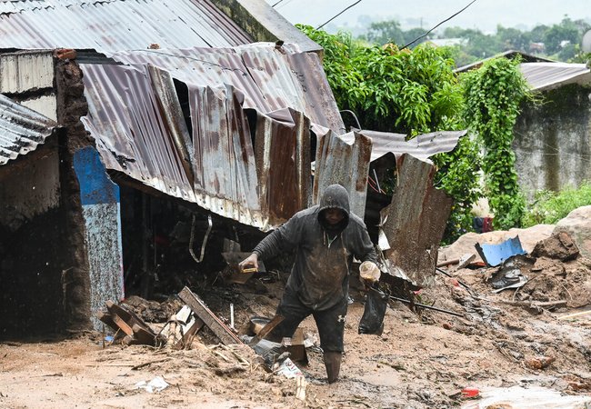 A man in Chilobwe Township in Blantyre picking something from the rubble of his house after mudslides, heavy rains and winds destroyed it