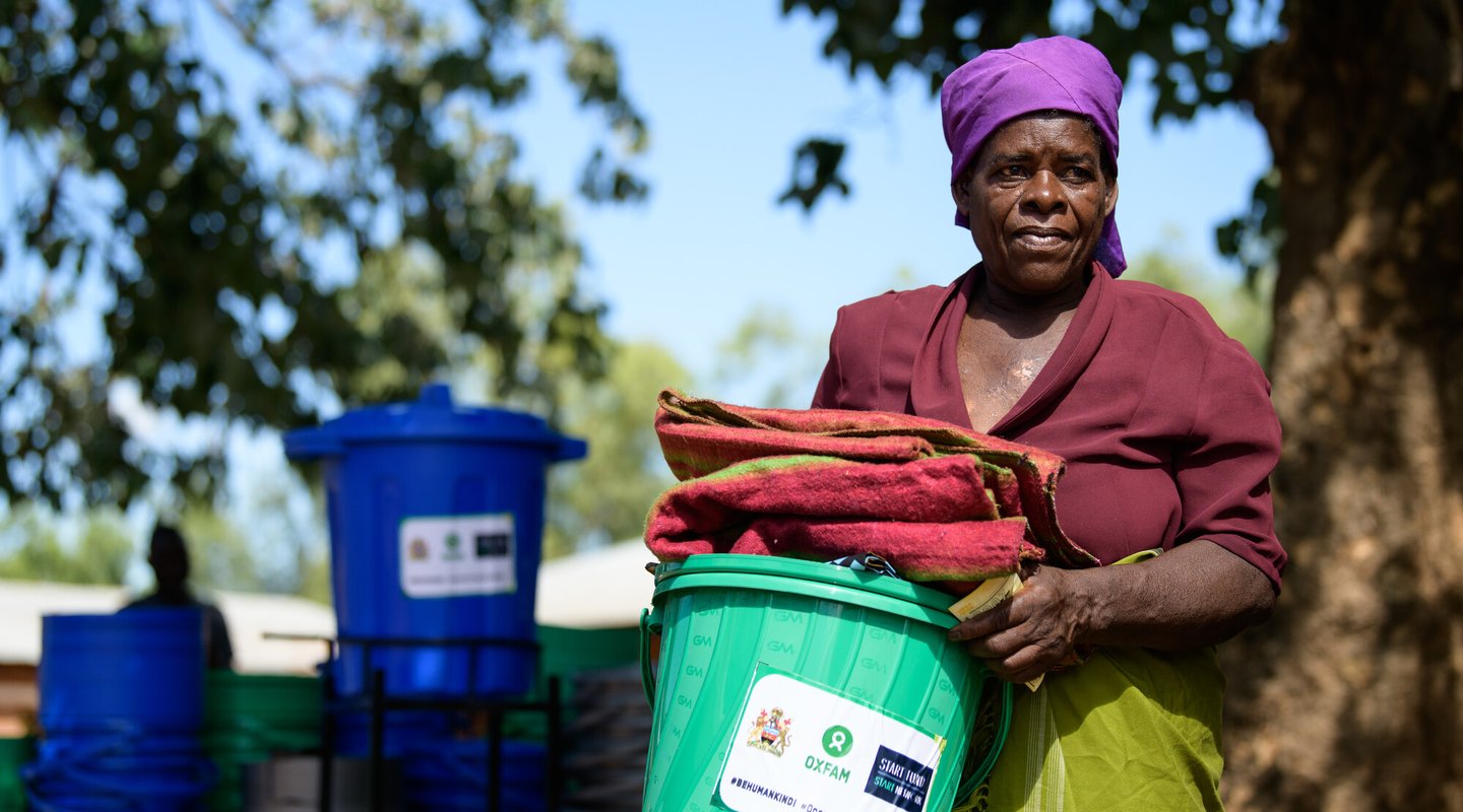 65-year-old Ligineti Nayinayi holds relief items from Oxfam Malawi in Phalombe, Southern Malawi.