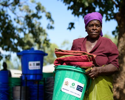 65-year-old Ligineti Nayinayi holds relief items from Oxfam Malawi in Phalombe, Southern Malawi.