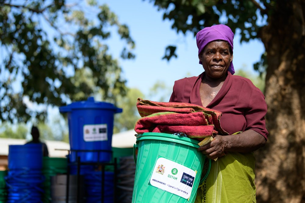 65-year-old Ligineti Nayinayi holds relief items from Oxfam Malawi in Phalombe, Southern Malawi.