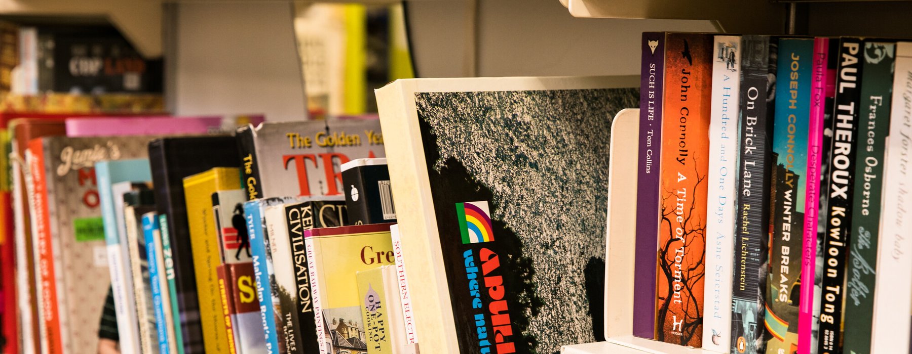 A shelf of donated books on display in Oxfam's Brighton & Hove bookshop.