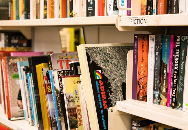 A shelf of donated books on display in Oxfam's Brighton & Hove bookshop.