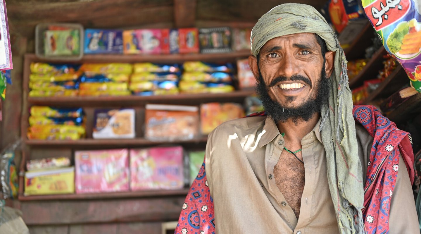 Ghulam smiles as he stands in his roadside shop in District Sanghar, Sindh, Pakistan.