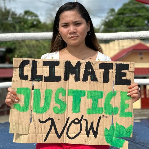 Marinel holding a protest card.